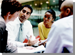 3 men and women working at table